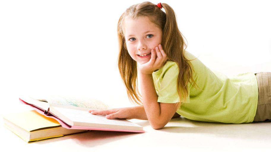 Girl lying down reading a book.
