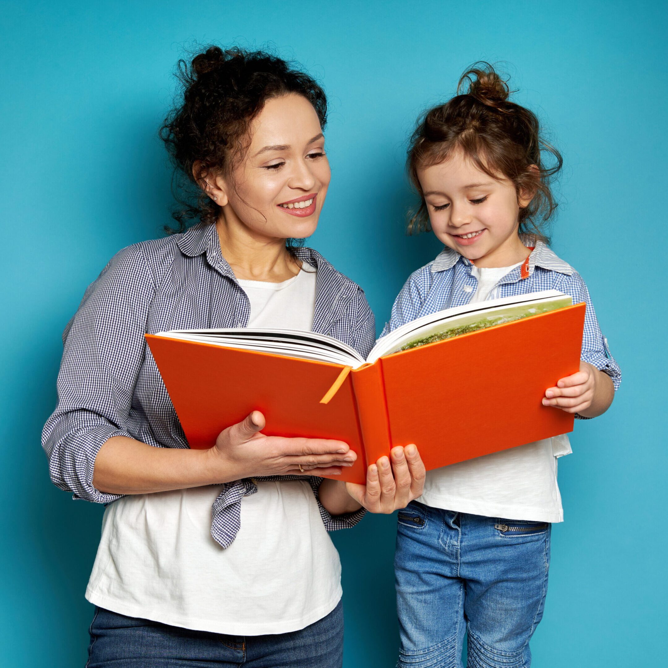 Mother and daughter reading a book.