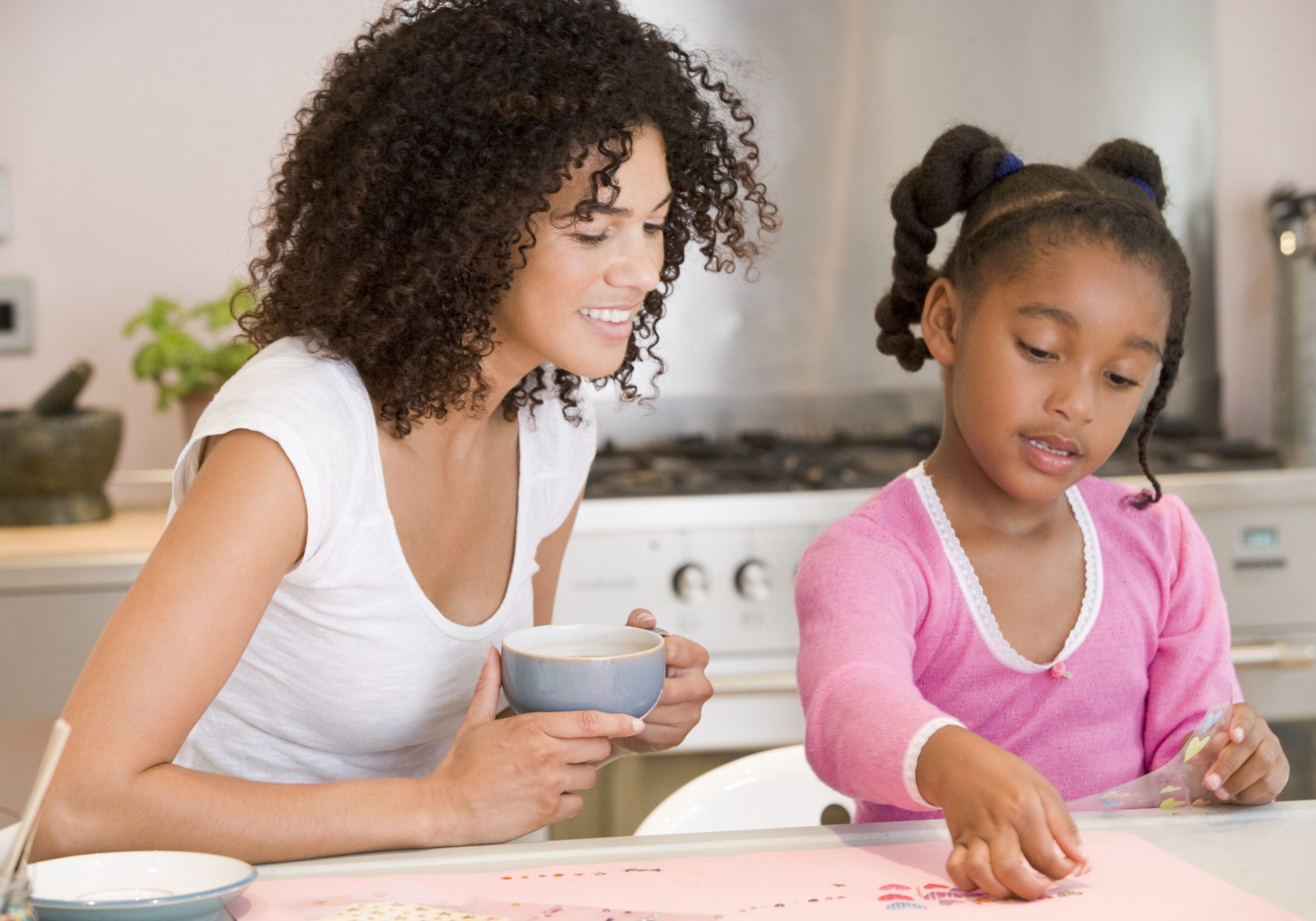 Woman and girl doing arts and crafts.